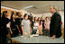 President George W. Bush speaks with science and engineering students after touring the Yvonne A. Ewell Townview Magnet Center in Dallas, Texas, Friday, Feb. 3, 2006.