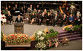 President George W. Bush addresses guests at the homegoing celebration for Coretta Scott King, Tuesday, Feb. 7, 2006 at the New Birth Missionary Church in Atlanta, Ga. In the background-right are Mrs. Laura Bush, former President Bill Clinton, U.S. Sen. Hillary Clinton, former President George H. W. Bush, former President Jimmy Carter, Mrs. Roslyn Carter and U.S. Sen. Edward M. Kennedy.