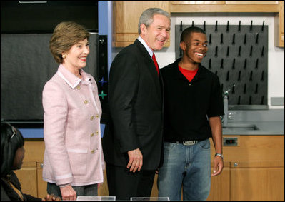 President George W. Bush and Mrs. Laura Bush greet student Michael Harrell during a visit with science and engineering students at the Yvonne A. Ewell Townview Magnet Center in Dallas, Texas, Friday, Feb. 3, 2006.