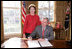 President George W. Bush is joined by Laura Bush, Wed. Feb. 1, 2006 in the Oval Office at the White House, as he signs a proclamation in honor of American Heart Month.