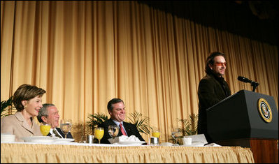 President George W. Bush, Laura Bush and Sen. Mark Pryor (D-Ark.) break out in laughter as Bono speaks during the National Prayer Breakfast Thursday morning at the Hilton Washington Hotel.