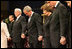 President George W. Bush and Mrs. Laura Bush are seen during a prayer holding hands with former President Bill Clinton, right, and Rev. Robert Schuller, left, at the homegoing celebration for Coretta Scott King, Tuesday, Feb. 7, 2006 at the New Birth Missionary Church in Atlanta, Ga.