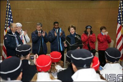 Mrs. Laura Bush, is joined by former Olympians, as she speaks to U.S. 2006 Winter Olympic athletes in Turin, Italy, Friday, Feb. 10, 2006, prior to the Winter Olympic opening ceremony.