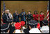 Mrs. Laura Bush, is joined by former Olympians, as she speaks to U.S. 2006 Winter Olympic athletes in Turin, Italy, Friday, Feb. 10, 2006, prior to the Winter Olympic opening ceremony.