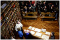 Laura Bush looks at an Ancient Thesis of Montichelli during a tour given by Enrico Artifoni, right, Paolo Novaria, right, and Andrea Carosso at the University of Turin Saturday, Feb. 11, 2006, in Turin, Italy.