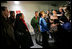 Laura Bush flanked by members of the U.S. Olympic Delegation, (from left) Roland Betts, Dr. Debi Thomas, Herschel Walker and Dr. Eric Heiden meet with members of the press after watching the Men’s U.S. Speed Skating competition at the 2006 Winter Olympics in Turin, Italy.