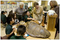 Laura Bush, listens to a student talk about Sea Turtles, Thursday, Feb. 16, 2006, as Fran Mainella, Director of the National Park Service, and Stella Summers, Teacher of the Gifted Science class, look on during a visit to Banyan Elementary School in Miami, FL, to support education about parks and the environment.