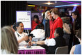 Mrs. Laura Bush is joined by Mrs. Irene Pollin, left, Friday, Feb. 17, 2006, while attending the National Woman's Heart Day Health Fair at the MCI Center in Washington. Mrs. Pollin is the founder and president of Sister to Sister, a national grassroots nonprofit organization offering free heart disease screenings and "heart-healthy" information and support to women to prevent heart disease.