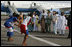 Mrs. Laura Bush and her daughter Barbara Bush are greeted by a cultural dance troupe upon their arrival Sunday, Jan. 15, 2006 at Kotoka International Airport in Accra, Ghana.