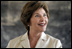 Mrs. Laura Bush smiles as she listens to a student at Model Secondary School Wednesday, Jan. 18, 2006, in Abuja, Nigeria. The visit came on the last of a four-day visit to West Africa.