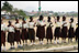 Students at Model Secondary School in Abuja, Nigeria, wave American flags as they line the street during a visit by Laura Bush Wednesday, Jan. 18, 2006.