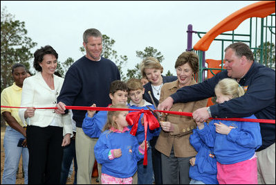 Laura Bush attends a ribbon cutting ceremony with football star Brett Favre and his wife, Deanna, left, Secretary Margaret Spelling, center, Dan Vogel, Associate Director, USA Fredom Corps, right, and student of Hancock North Central Elementary Shool at the Kaboom Playground, built at the Hancock North Central Elementary School in Kiln, Ms., Wednesday, Jan. 26, 2006, during a visit to the area ravaged by Hurricane Katrina.