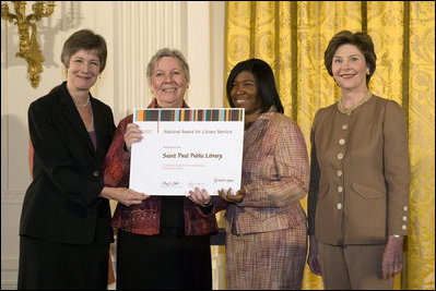 Laura Bush along with Mary Chute, Acting Director, Institute of Museums and Library Services, left, presents the 2005 National Awards for Museum and Library Services awards to St Paul Public Library Director, Kathleen Flynn, and Community Representative, Regina Harris, during a ceremony at the White House January 30, 2006. The Institute of Museum and Library Services’ National Awards for Museum and Library Service honor outstanding museums and libraries that demonstrate an ongoing institutional commitment to public service. It is the nation’s highest honor for excellence in public service provided by these institutions.