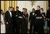 President George W. Bush and Mrs. Laura Bush hold jackets they were given by Special Olympics athletes after they listened to the band Rascal Flatts in the East Room of the White House following a dinner honoring the Special Olympics and founder Eunice Kennedy Shriver, Monday, July 10, 2006.