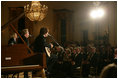 President George W. Bush, Mrs. Laura Bush and guests listen to the band Rascal Flatts in the East Room of the White House following a dinner honoring the Special Olympics and founder Eunice Kennedy Shriver, Monday, July 10, 2006.