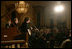 President George W. Bush, Mrs. Laura Bush and guests listen to the band Rascal Flatts in the East Room of the White House following a dinner honoring the Special Olympics and founder Eunice Kennedy Shriver, Monday, July 10, 2006.