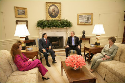 President George W. Bush and Mrs. Laura Bush visit with President Alejandro Toledo of Peru, and his wife and advisor, Mrs. Eliane Karp de Toledo, during a photo opportunity Tuesday, July 11, 2006, in the Oval Office.