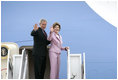 President George W. Bush and Laura Bush wave from Air Force One at Andrews Air Force Base en route to Germany and Russia Wednesday, July 12, 2006. President Bush will meet with Chancellor Angela Merkel in Germany and attend the G8 Summit in St. Petersburg, Russia.