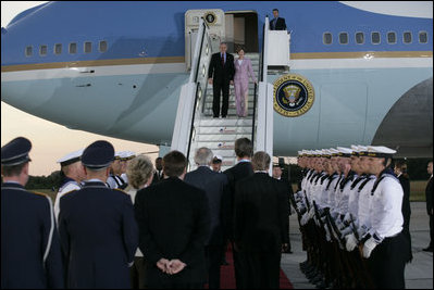 President George W. Bush and Laura Bush are greeted as they arrive Wednesday, July 12, 2006, at Rostock-Laage Airport in Rostock, Germany. The couple later boarded Marine One for a short ride to Heiligendamm, where they are the guests of Germany's Chancellor Angela Merkel before proceeding Friday to the G8 Summit in Russia.