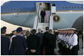 President George W. Bush and Laura Bush are greeted as they arrive Wednesday, July 12, 2006, at Rostock-Laage Airport in Rostock, Germany. The couple later boarded Marine One for a short ride to Heiligendamm, where they are the guests of Germany's Chancellor Angela Merkel before proceeding Friday to the G8 Summit in Russia.