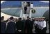 President George W. Bush and Laura Bush are greeted as they arrive Wednesday, July 12, 2006, at Rostock-Laage Airport in Rostock, Germany. The couple later boarded Marine One for a short ride to Heiligendamm, where they are the guests of Germany's Chancellor Angela Merkel before proceeding Friday to the G8 Summit in Russia.