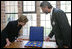 Mrs. Laura Bush is shown jewelry artifacts on her tour of the City of Stralsund Archives in Stralsund, Germany, Thursday, July 13, 2006, by Dr. Andreas Gruger, director of the Stralsund Museum of Cultural History.