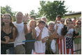 The President greets local residents. Well-wishers line the streets of Trinwillershagen, Germany, Thursday, July 13, 2006, awaiting a glimpse of President George W. Bush and Laura Bush as they arrive for a barbeque with German Chancellor Angela Merkel.