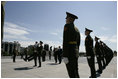 President George W. Bush and Laura Bush follow a Russian honor guard to place a wreath at the Monument to the Heroic Defenders of Leningrad, Friday, July 14, 2006, in St. Petersburg, Russia.