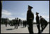 President George W. Bush and Laura Bush follow a Russian honor guard to place a wreath at the Monument to the Heroic Defenders of Leningrad, Friday, July 14, 2006, in St. Petersburg, Russia.