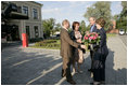 President George W. Bush and Laura Bush are greeted by Russian President Vladimir Putin and his wife, Lyudmila, upon their arrival Friday, July 14, 2006, for a social dinner at the Konstantinovsky Palace in Strelna, Russia.