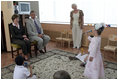 During a tour of the Pediatric HIV/AIDS Clinic Center of Russia, Mrs. Laura Bush and Dr. Evgeny Voronin listen to Gayla, a patient, perform in the Music Room Friday, July 14, 2006, in St. Petersburg, Russia. Music instructor Valentina Leontieva looks on.