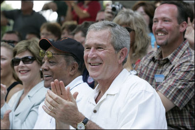 President George W. Bush and Laura Bush are joined by baseball legend and hall of famer Willie Mays, Tee Ball Commissioner for the day Sunday, July 30, 2006, at the Tee Ball on the South Lawn game between the Thurmont Little League Civitan Club of Frederick Challengers of Thurmont, Md., and the Shady Spring Little League Challenger Braves of Shady Spring, W. Va.