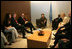 Ms. Barbara Bush talks about her experiences visiting AIDS clinics in Africa with U.S. Ambassador to the U.N. John Bolton, seated at her left, UN Secretary-General Kofi Annan, seated next to Mrs. Bush, and staff members during a visit to the United Nations in New York June 2, 2006. Mrs. Laura Bush also spoke about HIV/AIDS to the United Nations General Assembly's High-Level Meeting on AIDS.