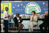 Mrs. Laura Bush joins Our Lady of Perpetual Help School principal Charlene Hursey, left, and Cardinal Theodore McCarrick, Archbishop of Washington, D.C., in applauding student Marquette Lewis, 11, after his reading of the poem "Coming of Age," Monday, June 5, 2006. Mrs. Bush visited the school to announce a Laura Bush Foundation for America's Libraries grant to Our Lady of Perpetual Help School.