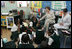 Mrs. Laura Bush talks with students during her visit to Our Lady of Perpetual Help School in Washington, Monday, June 5, 2006, where she announced a Laura Bush Foundation for America's Libraries grant to the school. Mrs. Bush is joined by Our Lady of Perpetual Help fifth grade teacher Julie Sweetland, right. 