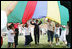 Mrs. Laura Bush participates in playing with a colorful parachute with children and staff outside the Meadowbrook Collaborative Community Center, Tuesday, June 6, 2006 in St. Louis Park. Minn.