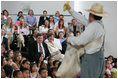 Mrs. Laura Bush watches Ricardo Araiza, one of the two actors, perform in the Childsplay production of Tomas and the Library Lady, at the Boys and Girls Club of the East Valley in Guadalupe, Arizona on June 16, 2006. The play promotes literacy and encourages young people to look past the confines of poverty, language barriers and cultural intolerance to find joy in reading.