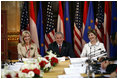 President George W. Bush and Laura Bush are joined by U.S. Ambassador to Austria Susan McCaw during a roundtable discussion Wednesday, June 21, 2006, with foreign students at the National Library in Vienna.