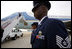 President George W. Bush and Mrs. Laura Bush board Air Force One June 21, 2006, at Andrews Air Force Base on their way to Vienna, Austria. Air Force personel await the departure, in the foreground.