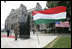 President George W. Bush and Mrs. Laura Bush stand in silence after laying flowers at the eternal flame of the 1956 Memorial Monument outside the Hungarian Parliament in Budapest, Hungary, Thursday, June 22, 2006. The monument honors victims of the 1956 Hungarian uprising against Soviet rule.