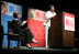 Mrs. Laura Bush applauds Caitlyn Clarke, high school Student of the Year for Jefferson Parish Public School System, Monday, June 26, 2006, as Miss Clarke speaks of her passion for reading before introducing Mrs. Bush during the 2006 American Library Association Conference in New Orleans, Louisiana.