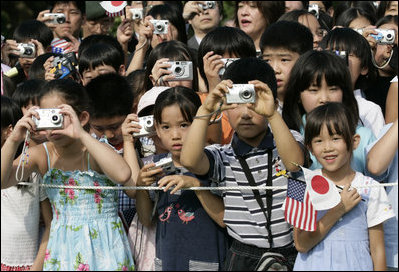 President George W. Bush and Prime Minister Junichiro Koizumi of Japan are greeted by an enthusiastic crowd of young guests during an arrival ceremony on the South Lawn Thursday, June 29, 2006.