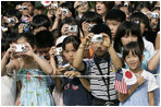 President George W. Bush and Prime Minister Junichiro Koizumi of Japan are greeted by an enthusiastic crowd of young guests during an arrival ceremony on the South Lawn Thursday, June 29, 2006.