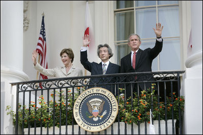 President George W. Bush, Laura Bush and Prime Minister Junichiro Koizumi of Japan wave from the Truman Balcony at the conclusion of the official arrival ceremony Thursday, June 29, 2006.