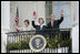 President George W. Bush, Laura Bush and Prime Minister Junichiro Koizumi of Japan wave from the Truman Balcony at the conclusion of the official arrival ceremony Thursday, June 29, 2006.