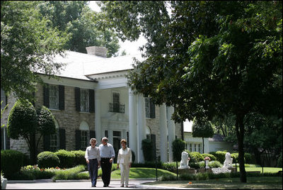 President George W. Bush, Laura Bush and Japanese Prime Minister Junichiro Koizumi, wearing a pair of Elvis-style sunglasses, tour the grounds of Graceland, the home of Elvis Presley, Friday, June 30, 2006, in Memphis.