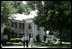 President George W. Bush, Laura Bush and Japanese Prime Minister Junichiro Koizumi, wearing a pair of Elvis-style sunglasses, tour the grounds of Graceland, the home of Elvis Presley, Friday, June 30, 2006, in Memphis.