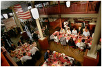 President George W. Bush, Laura Bush, and Japanese Prime Minister Junichiro Koizumi sit down for a bar-b-que lunch at Rendezvous restaurant, Friday, June 30, 2006, in Memphis, Tennessee, after taking a tour of Graceland and visiting the National Civil Rights Museum.