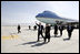 President George W. Bush gives the thumbs-up after Air Force One landed at Bagram Air Base near Kabul, Afghanistan Wednesday, March 1, 2006. The five-hour surprise visit included a meeting with Afghan President Karzai, a ceremonial ribbon-cutting at the U.S. Embassy, and a visit to the troops at Bagram.