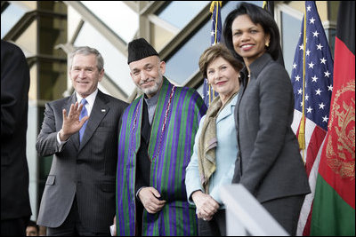 President George W. Bush waves as he stands with President Hamid Karzai of Afghanistan, Mrs. Laura Bush and Secretary of State Condoleezza Rice during welcoming ceremonies Wednesday, March 1, 2006, in Kabul.